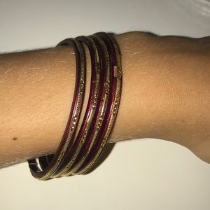 Set of 4 dangle hoop bracelets.